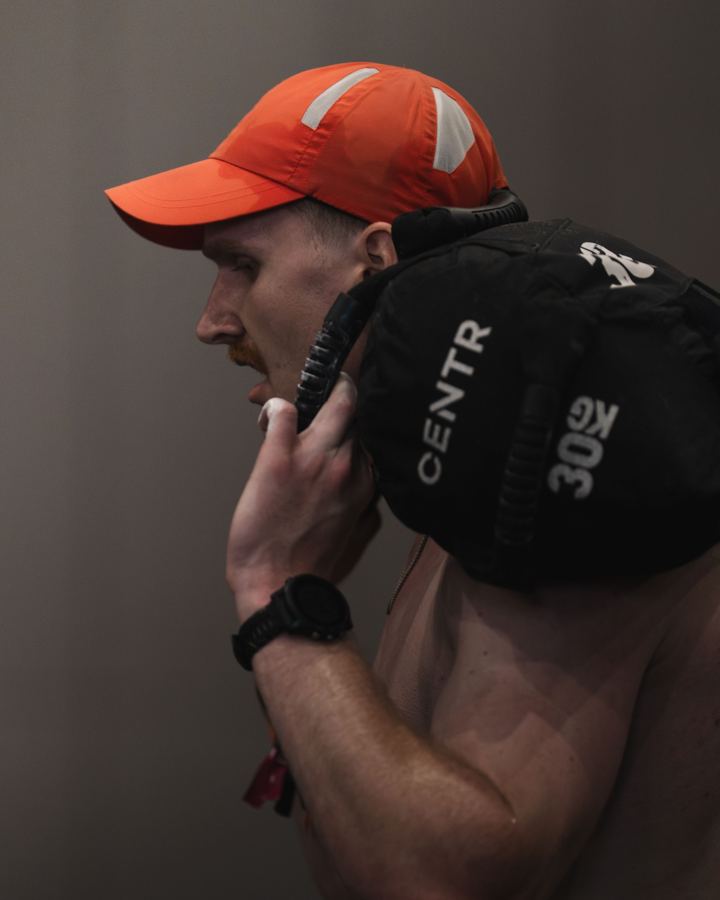 Close-up of Luke carrying a sandbag